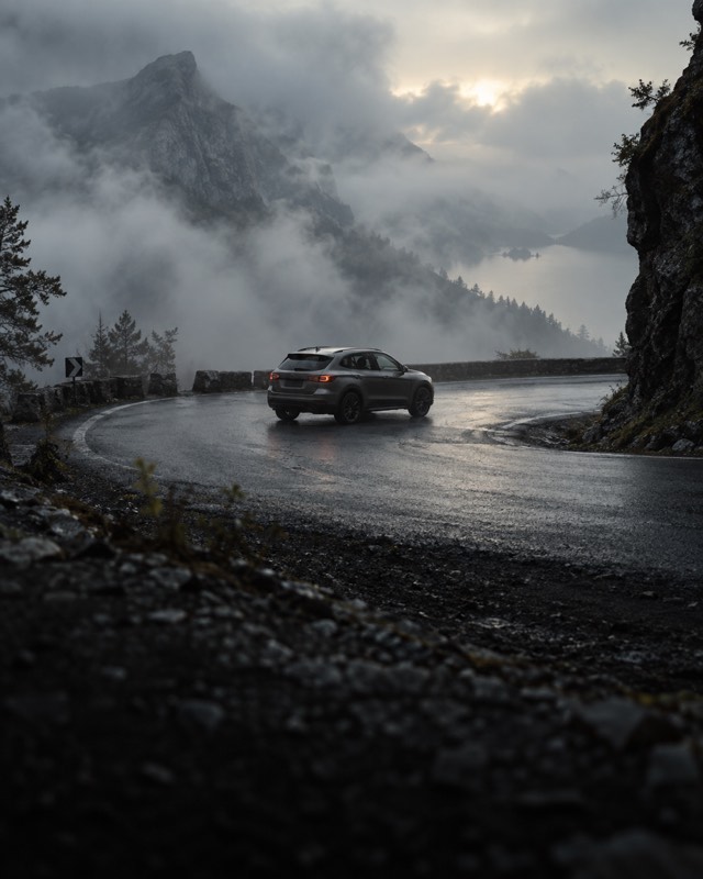 A car on a winding mountain road.